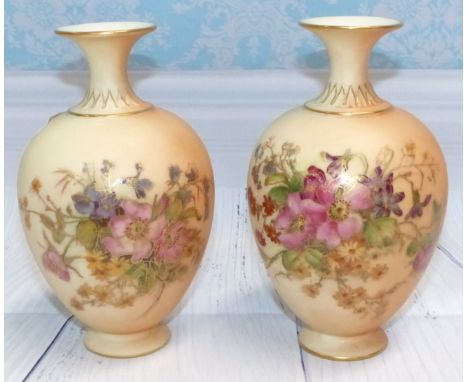 A pair of late 19th Century Royal Worcester porcelain ovoid baluster vases, hand painted with floral decoration against a pea