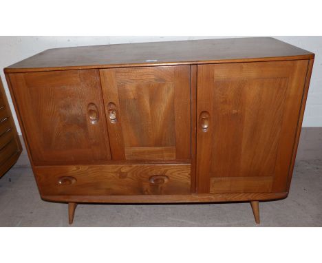 An Ercol light elm sideboard of 3 cupboards and a drawer