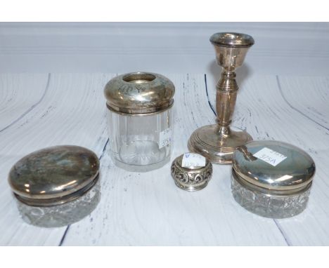A pair of small trinket jars with hallmarked silver tops; a silver top hair tidy and a silver candlestick