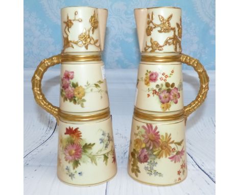 A pair of late 19th Century Royal Worcester porcelain cylindrical jugs of slender tapering form, ivory with gilt handles and 