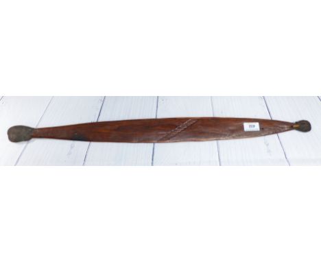 A 19th century Australian aboriginal hard wood throwing stick, crude incised decoration, 30"