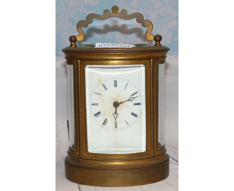 A 19th century brass carriage clock in oval case, with white enamel dial and 8 day movement striking on bell by Rollin, Paris