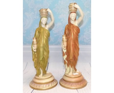 A pair of late 19th Century Royal Worcester porcelain female water carriers in muted green and brown, heights 10" & 10½" (one