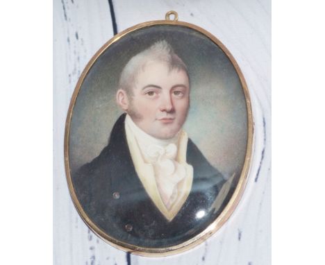 An early 19th century head and shoulders miniature portrait on ivory of a young man, with woven hair memorial back, 7.8 x 6.2