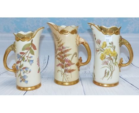  A pair of late 19th Century Royal Worcester porcelain jugs, ivory ground, height 6.5”; a similar peach jug, 6.5”