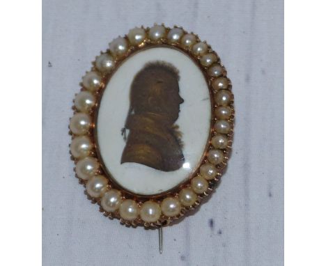 An early 19th century silhouette miniature portrait on ivory with gilt highlights, yellow metal brooch mount (untested), with