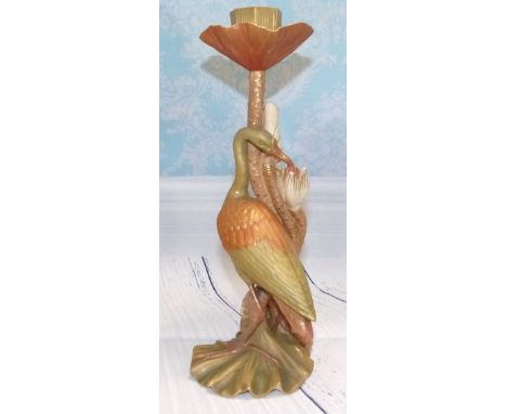 A late 19th Century Royal Worcester porcelain candlestick with the stem in the form of a heron and entwined flowering lily, i