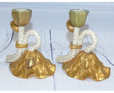 A pair of late 19th Century Royal Worcester gilded candlesticks in the form of lily flowers, on domed lily bases with frogs, 