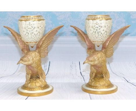 A Royal China Works Worcester pair of ovoid reticulated vases supported on birds of prey height 7"
