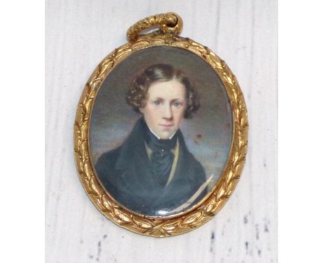 An early 19th century head and shoulders miniature portrait on ivory of a young man, vacant reserve en verso, in chased gilt 