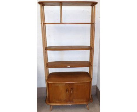 An Ercol light elm room divider with 4 shelves and double cupboard