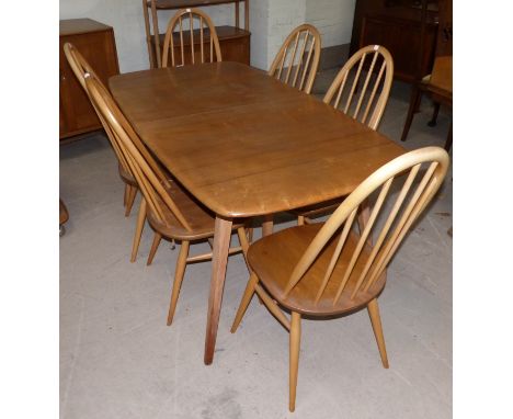 An Ercol light elm dining suite comprising rectangular extending table and 6 hoop and stick back chairs