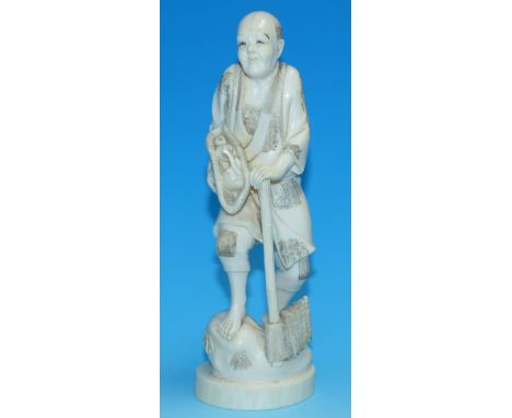 A 19th century Japanese carved ivory figure of a man with an axe, signature to base, 8.25"