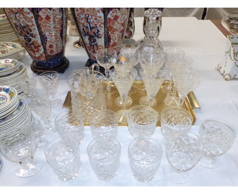 A large cut glass mallet shaped decanter; a selection of cut drinking glasses