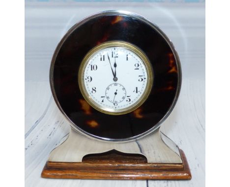 A tortoiseshell and silver circular dressing table clock, date mark worn, height 5"
