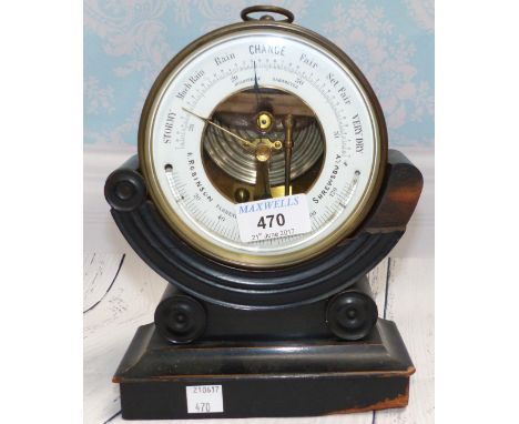 A brass circular aneroid barometer with thermometer by R Robinson, Shrewsbury, in ebonised cradle