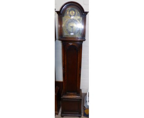 An early 20th century oak long case clock with arch top, brass dial and triple weight driven movement