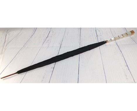 An Art Deco umbrella, the tapering handle in alternating mother-of-pearl and 9 carat gold