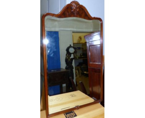 A period style arch top wall mirror in carved walnut frame, height 36"