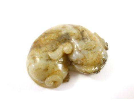 A Chinese jade carving of a buddhist lion, 19th/20th century, in recumbent pose with head resting on its front paws, 6cm. wid