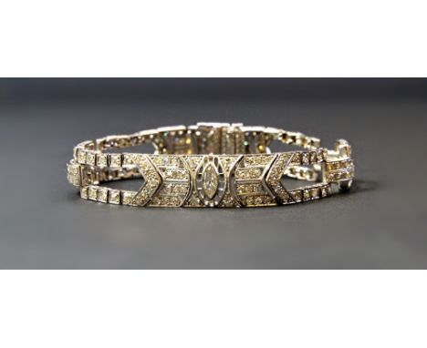 A platinum and diamond set bracelet, in a geometric twin bar and panel shaped Art Deco design, mounted with the principal mar