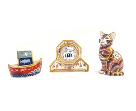 A Royal Crown Derby 'Royal Antoinette' porcelain mantel clock, 10.5cm high, boxed, and two second quality Imari paperweights;