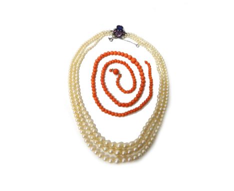 A three row necklace of graduated cultured pearls, on an amethyst and gem set clasp, fitted with a safety chain and a single 