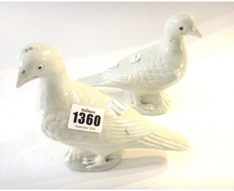 A pair of Chinese porcelain white glazed  pigeons, 19th century, facing to the left or right, the eyes picked out in black en