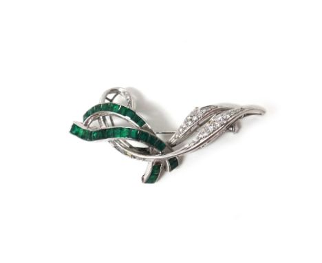 An white gold, emerald and diamond set brooch, designed as a spray, mounted with baguette and circular cut diamonds and with 