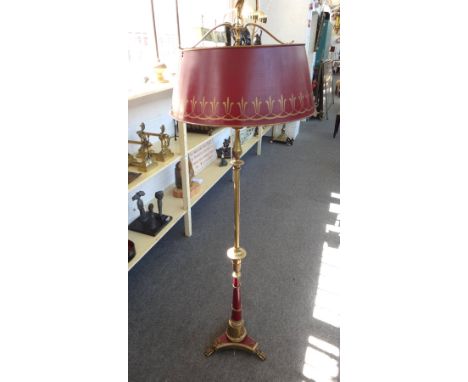 An Empire style bouillotte standard lamp with burgundy gilt tin shade, on a triform base and lion's paw feet, 170cm high.