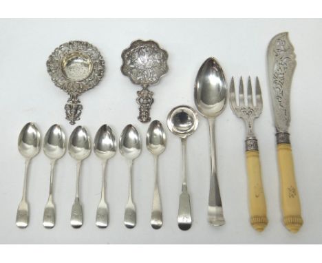 A decorative sugar sifting spoon, the cast and pierced handle having a masked finial, import mark London 1891, a straining sp