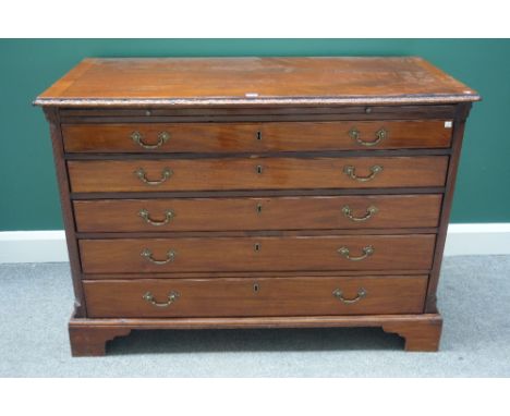 A late 18th century German mahogany commode, the brushing slide over five long graduated drawers flanked by fluted canted sup