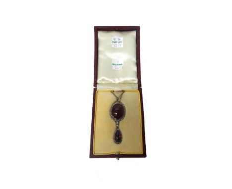 A carbuncle garnet and rose diamond set pendant necklace, the top with the principal oval carbuncle garnet at the centre, in 