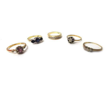 A gold ring, mounted with three oval cut sapphires and with two curved rows of four circular cut diamonds, detailed 18 CT, a 