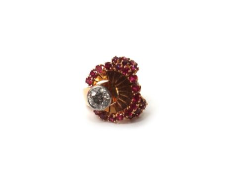 A gold, diamond and synthetic ruby set cocktail ring, collet set with the principal cushion shaped diamond in a semi-circular