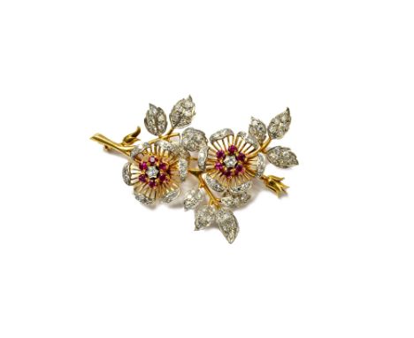 A gold, diamond and ruby set brooch, designed as a floral spray, mounted with circular cut diamonds and with circular cut rub