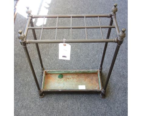 A Victorian tubular brass twelve division stick stand, of rectangular form, with turned finials and a metal drip tray, 64.5cm
