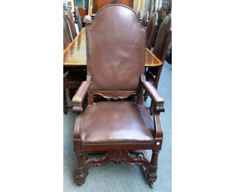 A set of twelve late 19th century carved mahogany framed dining chairs, each with studded leather upholstered high arch back,