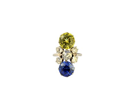 A diamond, synthetic yellow sapphire and synthetic blue sapphire set ring, claw set with the principal cushion shaped diamond
