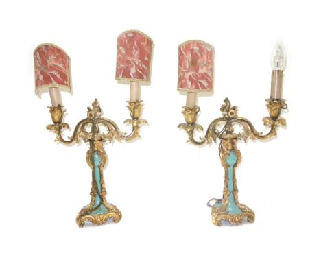 A pair of ormolu and green glazed twin light candelabra, 19th century, (a.f), 34cm high excluding fitments. (2)