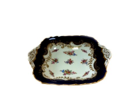 A Coalport dessert service for twelve, early 20th century, with printed and coloured flowers within a cobalt blue border, com