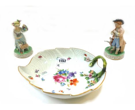 A 20th century Meissen porcelain dish of leaf form, 25cm wide, a Meissen teapot, three Meissen teacups and saucers of quatral