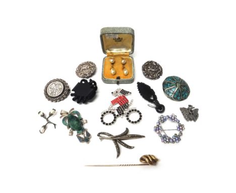 A group of Jewellery, comprising; a Butler and Wilson brooch, designed as a dog on a bicycle, seven further brooches, a carve