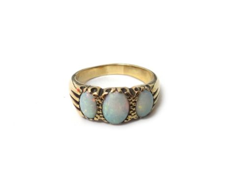 A gold and opal set three stone ring, mounted with a row of oval opals, ring size S and a half.