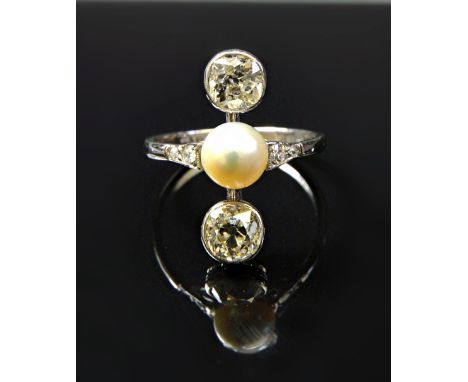 A white gold and platinum ring, mounted with a cultured pearl at the centre, between the two principal collet set cushion sha