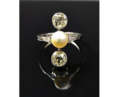 A white gold and platinum ring, mounted with a cultured pearl at the centre, between the two principal collet set cushion sha