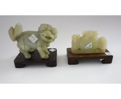 Four Chinese jade groups, 20th century, comprising; a carving of a man standing with a basket, 12cm. high; a Buddhist lion, 1