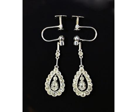 A pair of white gold and diamond set pendant earrings, each with a pear shaped drop, the centre claw set with a pear shaped d