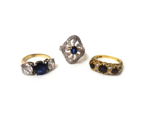 A gold ring, mounted with three circular cut sapphires and with two pairs of small circular cut diamonds, mounted at interval