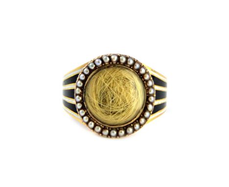 A gold, enamelled and seed pearl set mourning ring, glazed with a circular hair locket compartment to the centre, within a su